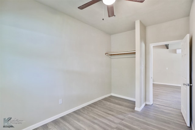 unfurnished bedroom featuring light hardwood / wood-style floors, a closet, and ceiling fan