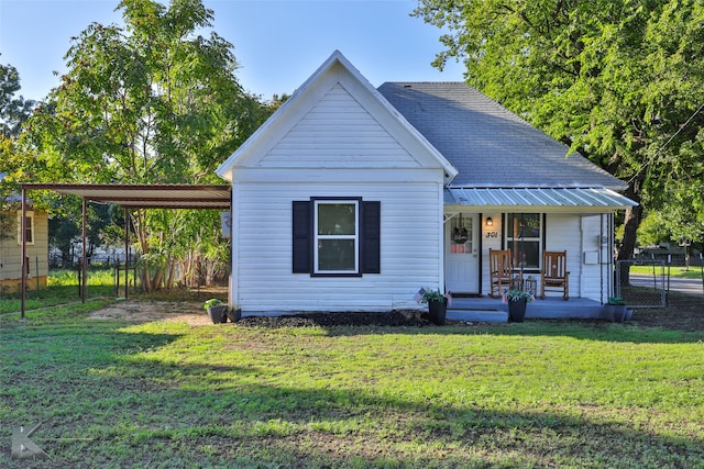 view of front of property with a carport and a front lawn