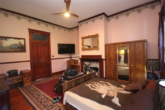 968 Mounce Rd, Grand Cane, LA 71032 - bedroom with ceiling fan, a fireplace, ornamental molding, and dark hardwood / wood-style flooring