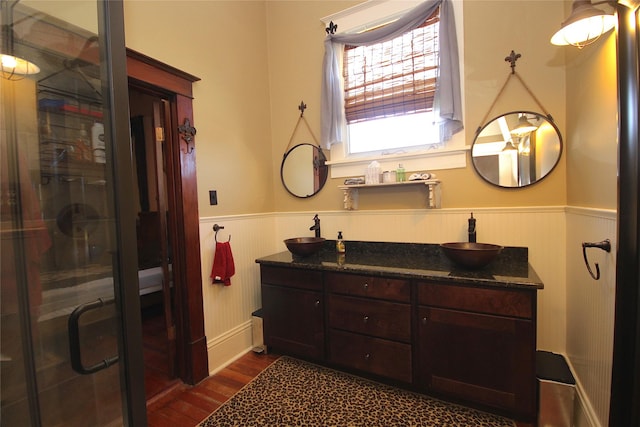 968 Mounce Rd, Grand Cane, LA 71032 - bathroom featuring hardwood / wood-style flooring, vanity, wooden walls, and an enclosed shower