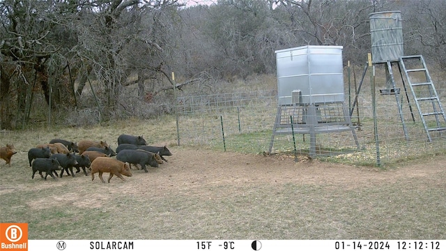 view of yard featuring a rural view and an outdoor structure