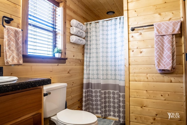 bathroom with a wealth of natural light, vanity, wooden ceiling, and wood walls