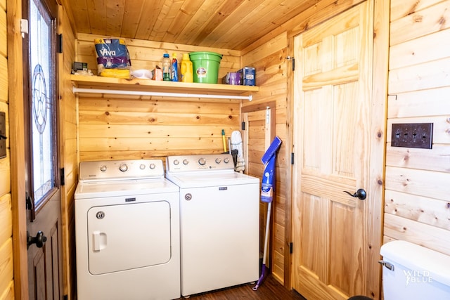 laundry area featuring dark hardwood / wood-style flooring, wooden walls, washer and clothes dryer, and wood ceiling