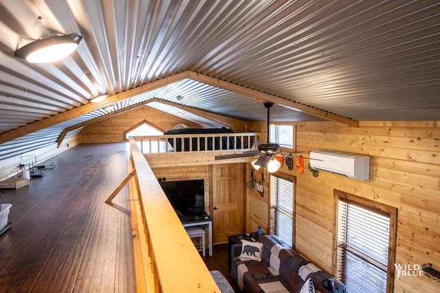 additional living space featuring a wall mounted air conditioner, lofted ceiling, wooden walls, ceiling fan, and dark hardwood / wood-style flooring