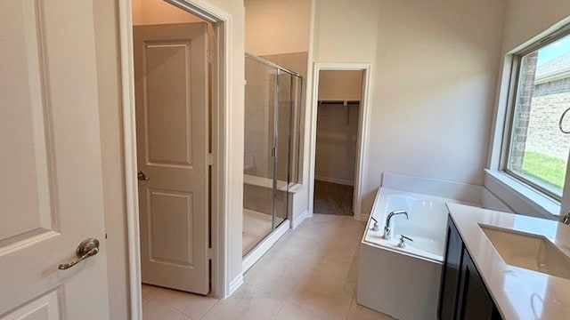 bathroom featuring sink, shower with separate bathtub, and tile patterned floors