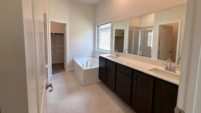 bathroom with tile patterned floors, separate shower and tub, and double sink vanity