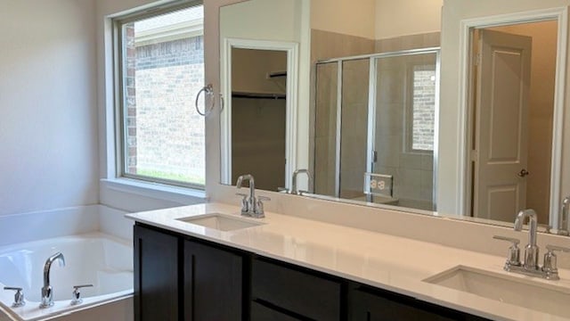 bathroom with independent shower and bath and double sink vanity