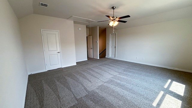 unfurnished bedroom with dark colored carpet, ceiling fan, and lofted ceiling