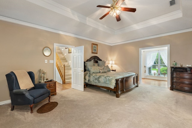 bedroom with a raised ceiling, ceiling fan, light colored carpet, and ornamental molding