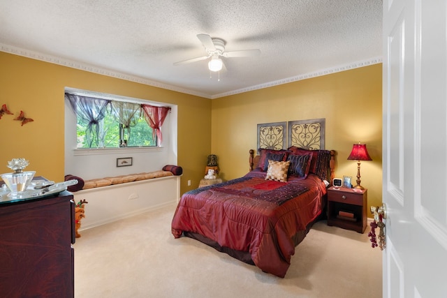 bedroom with a textured ceiling, ceiling fan, crown molding, and light carpet