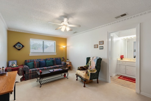 living room with light carpet, crown molding, ceiling fan, and a textured ceiling