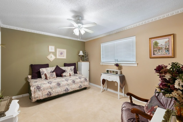 carpeted bedroom with a textured ceiling, ceiling fan, and ornamental molding