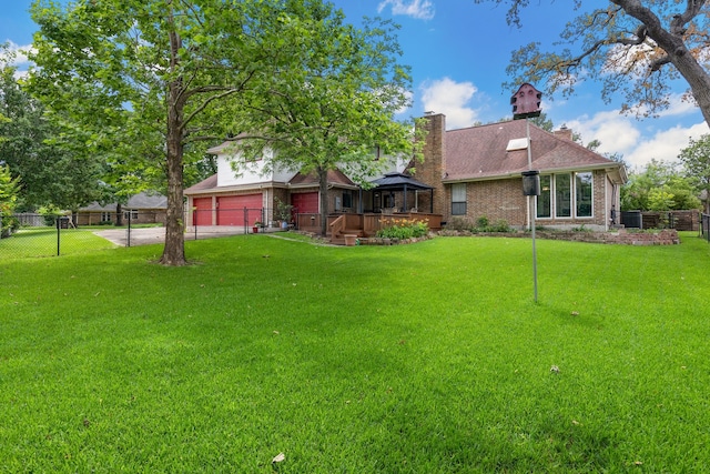exterior space with a gazebo, concrete driveway, an attached garage, and fence