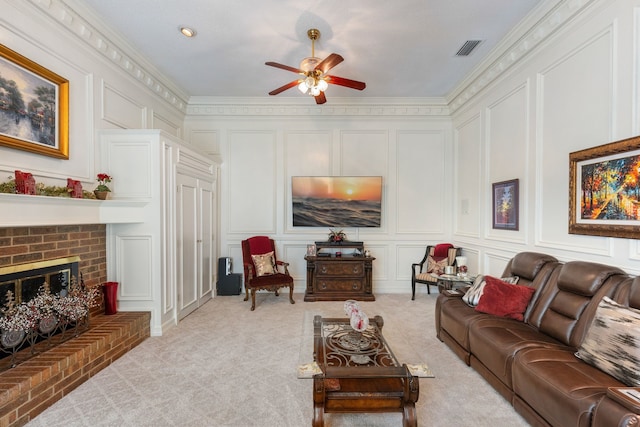 living room with light carpet, a brick fireplace, ceiling fan, and ornamental molding