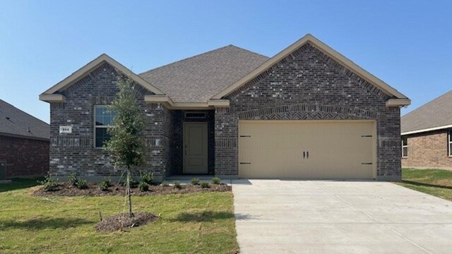 211 Bobcat Ln, Caddo Mills, TX 75135 - view of front of property with a front lawn, concrete driveway, an attached garage, and brick siding