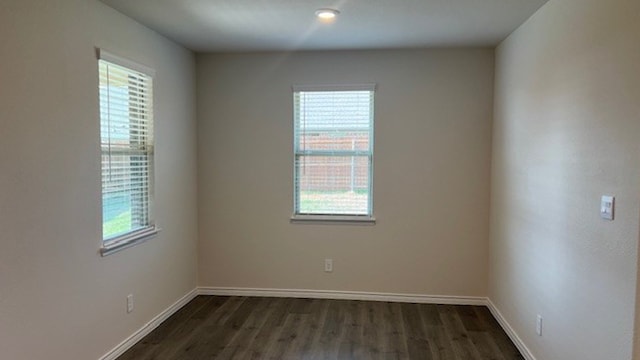 unfurnished room featuring dark hardwood / wood-style flooring and plenty of natural light