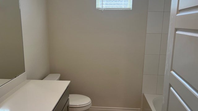 full bathroom featuring shower / tub combination, vanity, and toilet