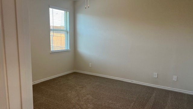 empty room with dark carpet