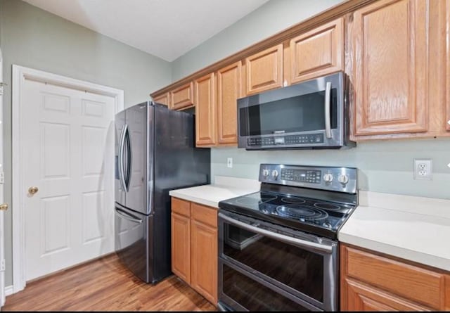 kitchen featuring appliances with stainless steel finishes and light wood-type flooring