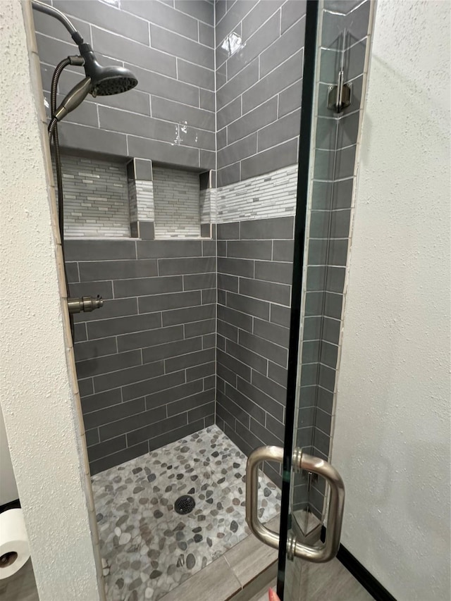 bathroom with a shower with shower door