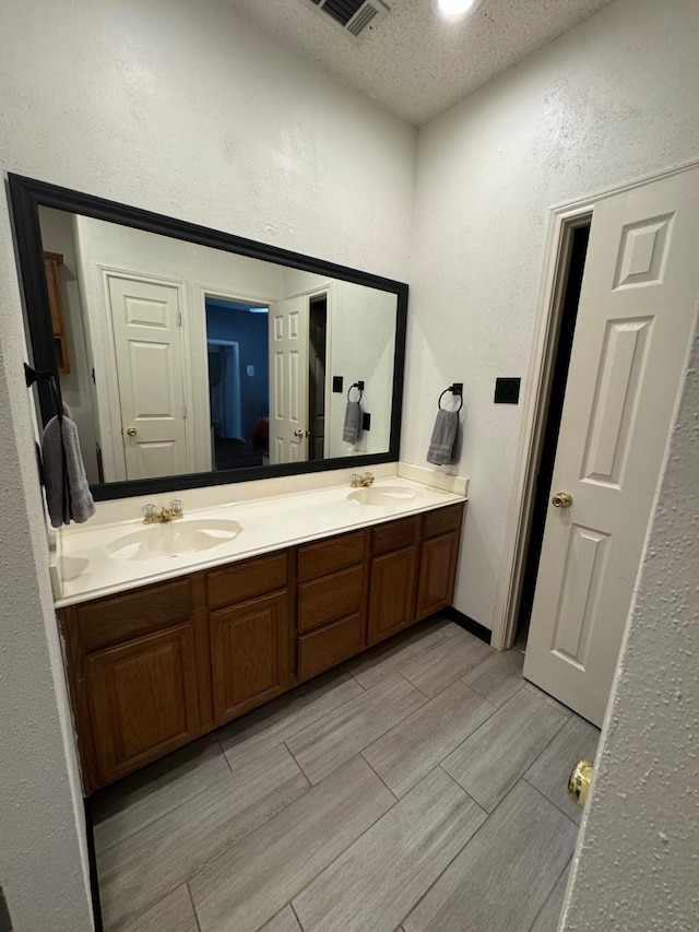 bathroom featuring vanity and a textured ceiling