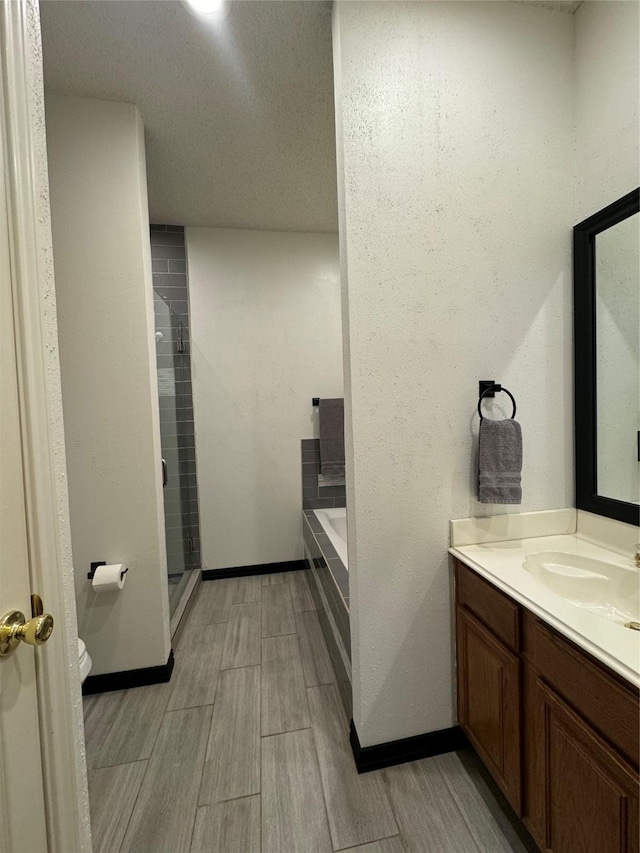 full bathroom with vanity, toilet, and independent shower and bath