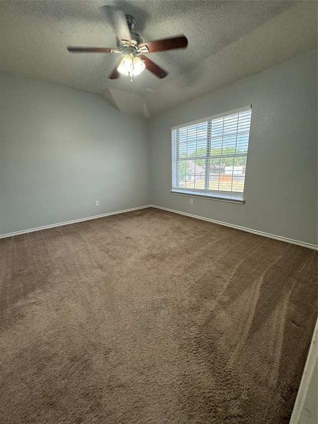 carpeted empty room featuring ceiling fan and a textured ceiling