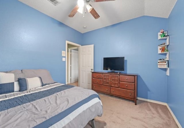 bedroom with light colored carpet, vaulted ceiling, and ceiling fan