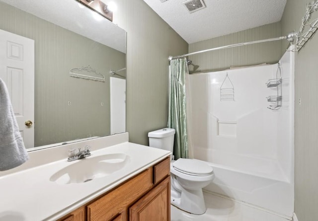 full bathroom featuring tile patterned flooring, a textured ceiling, toilet, shower / bath combo with shower curtain, and vanity