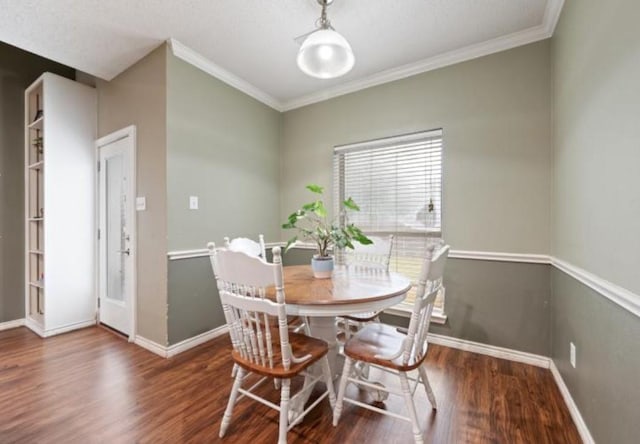 dining space featuring crown molding and dark wood-type flooring