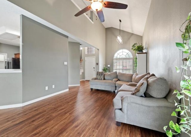 living room with dark hardwood / wood-style floors, high vaulted ceiling, and ceiling fan