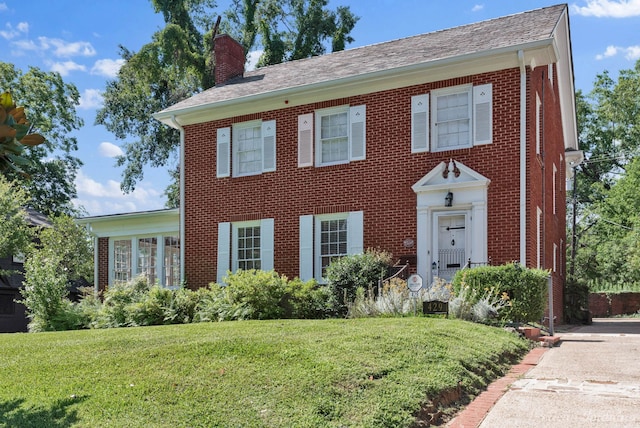 colonial-style house with a front yard