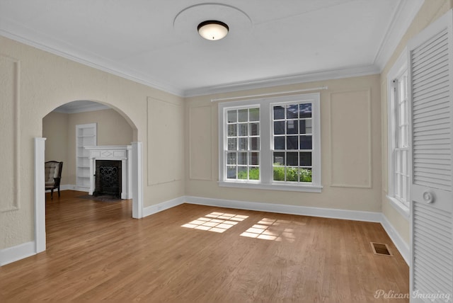 spare room with light hardwood / wood-style flooring and ornamental molding