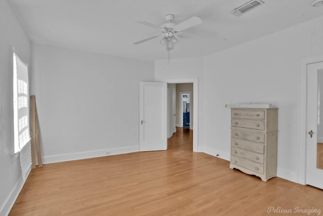 interior space featuring multiple windows, light wood-type flooring, and ceiling fan