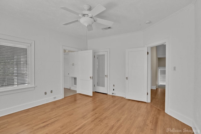 unfurnished bedroom with ceiling fan, light hardwood / wood-style flooring, and a textured ceiling