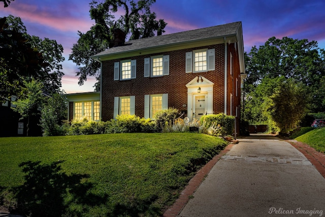 colonial-style house featuring a yard