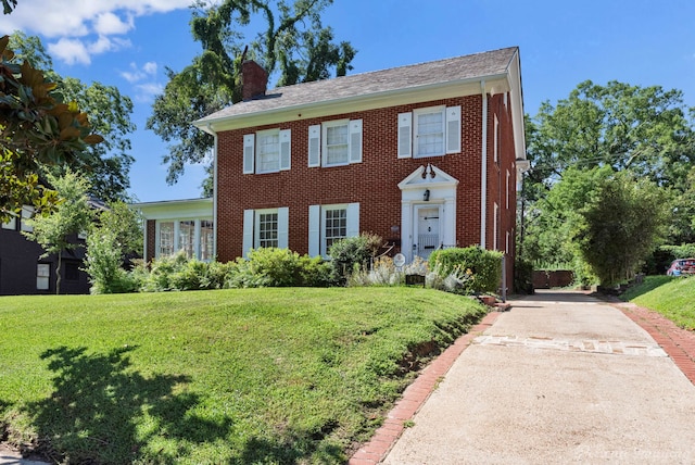 colonial inspired home with a front yard