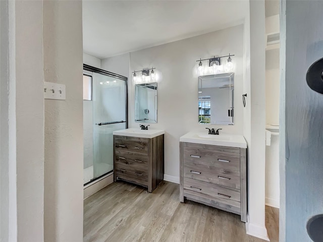 bathroom featuring vanity, hardwood / wood-style flooring, and walk in shower