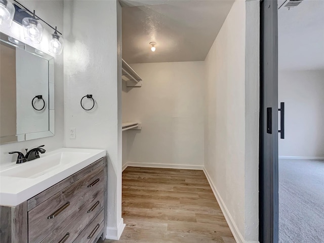 bathroom featuring vanity and hardwood / wood-style flooring