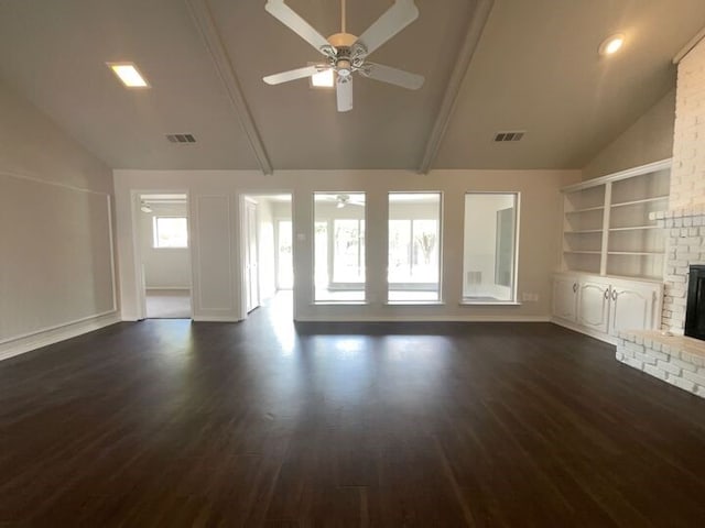 unfurnished living room featuring lofted ceiling with beams, dark wood-type flooring, ceiling fan, and a brick fireplace