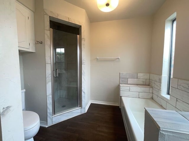 bathroom with independent shower and bath, toilet, and wood-type flooring