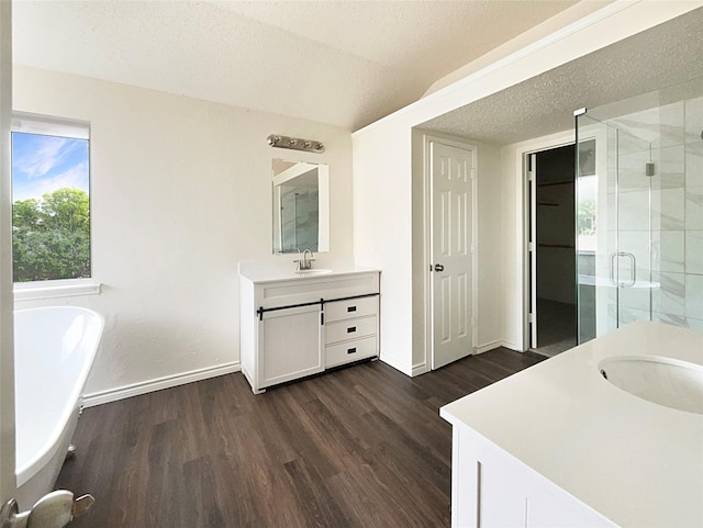 bathroom featuring vanity, a textured ceiling, plus walk in shower, hardwood / wood-style floors, and lofted ceiling