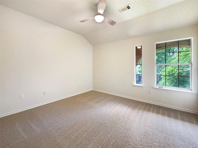 empty room featuring carpet flooring, a textured ceiling, ceiling fan, and lofted ceiling