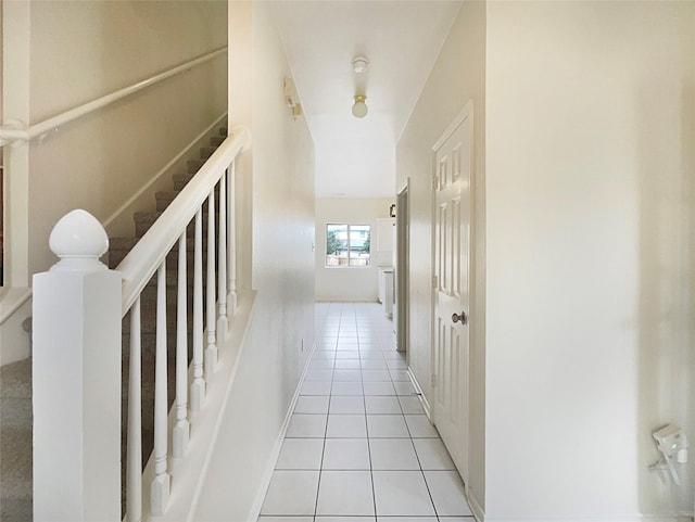 corridor with light tile patterned flooring