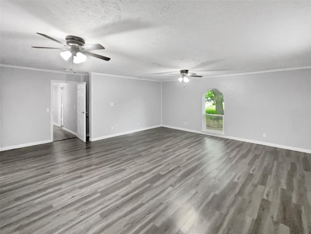 empty room featuring dark hardwood / wood-style flooring, ornamental molding, and a textured ceiling