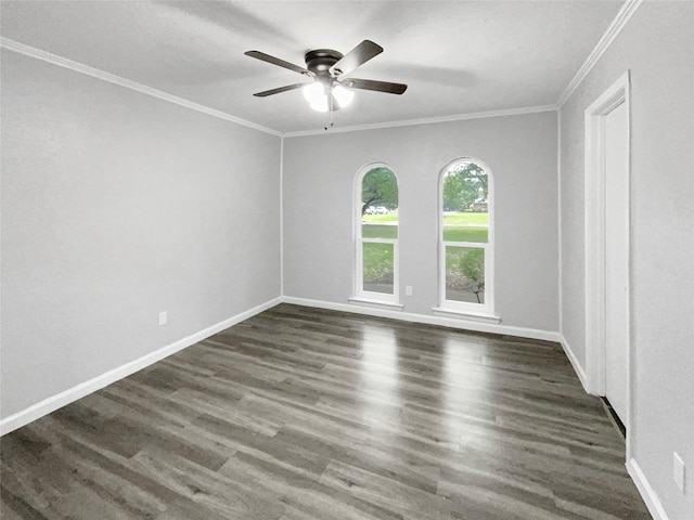 empty room with ornamental molding, ceiling fan, and dark wood-type flooring