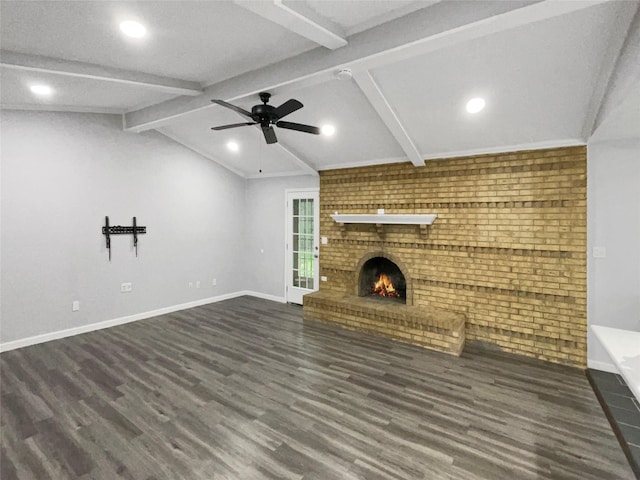 unfurnished living room featuring a fireplace, vaulted ceiling with beams, dark hardwood / wood-style flooring, and ceiling fan