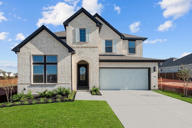 view of front facade with a front lawn and a garage