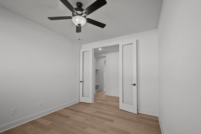 unfurnished bedroom with ceiling fan and light hardwood / wood-style flooring