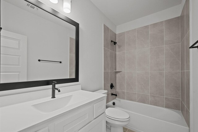 full bathroom featuring vanity, tiled shower / bath combo, and toilet